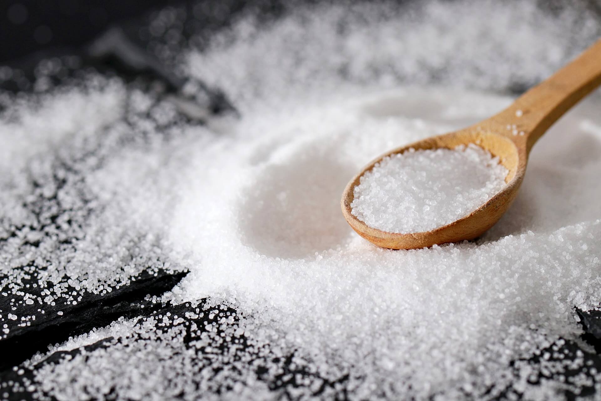 Photo: A small wooden spoon full of salt rests in a small pile of salt.